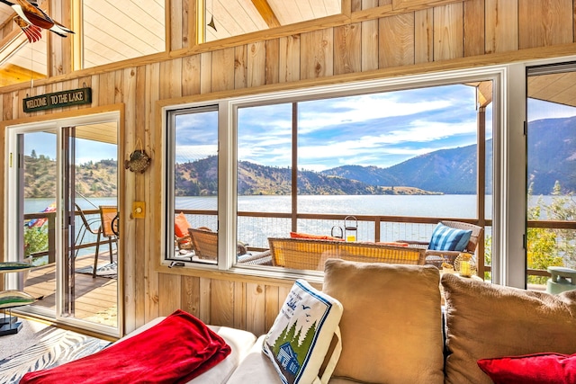 sunroom / solarium featuring a water and mountain view