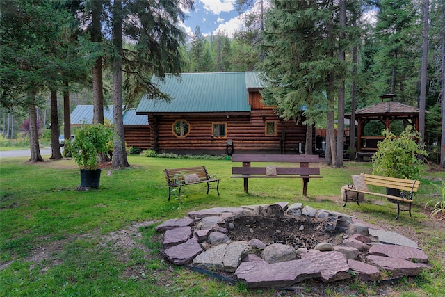 view of yard featuring a gazebo and a fire pit