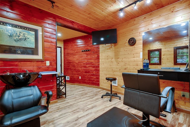 office space with track lighting, wooden ceiling, wood finished floors, and wood walls
