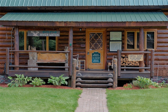 entrance to property featuring metal roof
