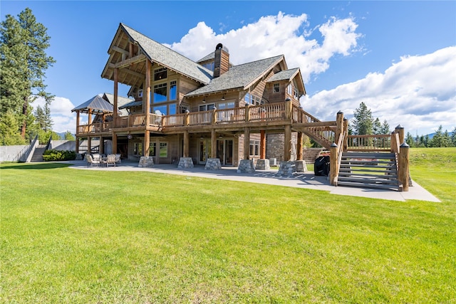 back of house with stairs, a yard, a deck, and a patio area