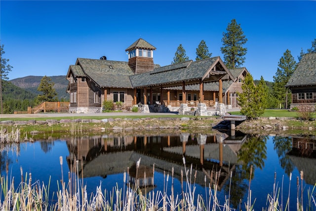 back of house with a water and mountain view