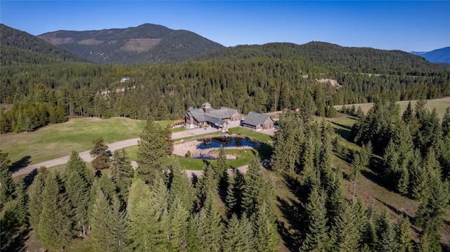 drone / aerial view with a mountain view and a wooded view