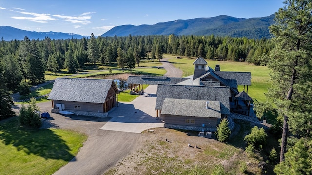 birds eye view of property featuring a forest view and a mountain view