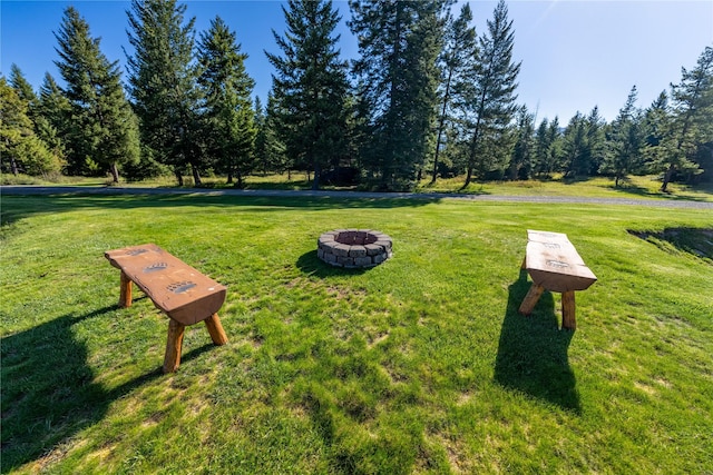 view of home's community with a yard and a fire pit