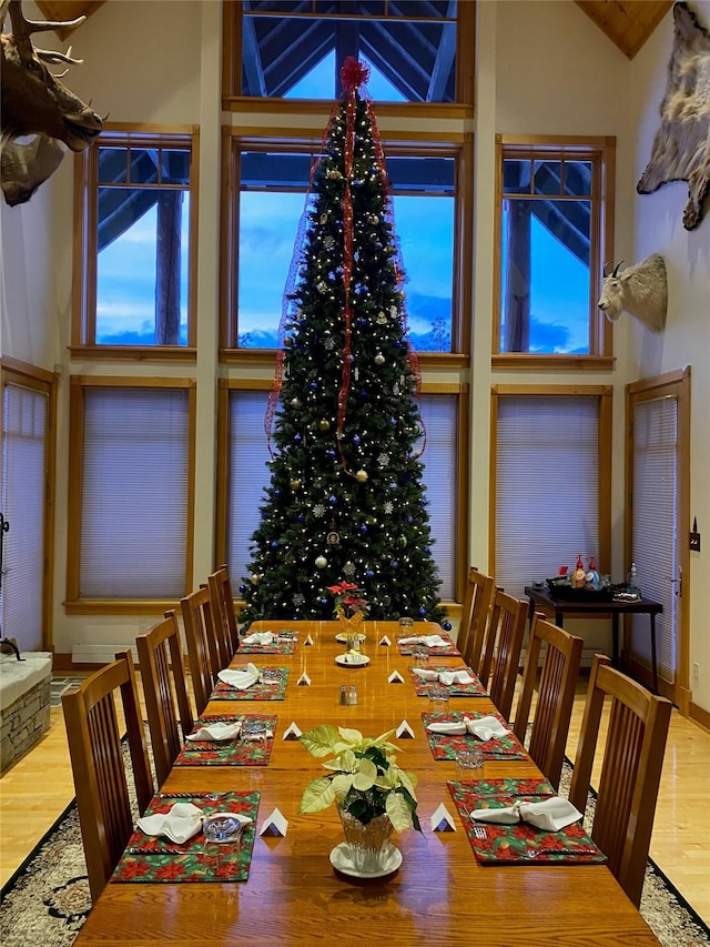 dining space with lofted ceiling and wood finished floors