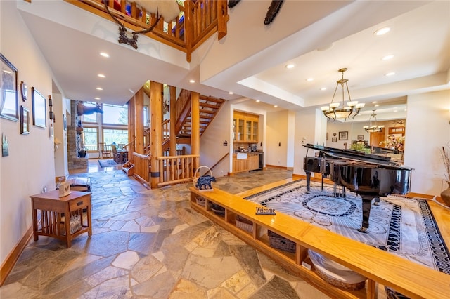 interior space with stone tile floors, stairway, and baseboards