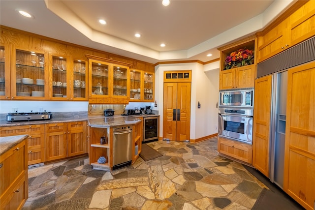 kitchen featuring stone tile floors, beverage cooler, glass insert cabinets, built in appliances, and open shelves