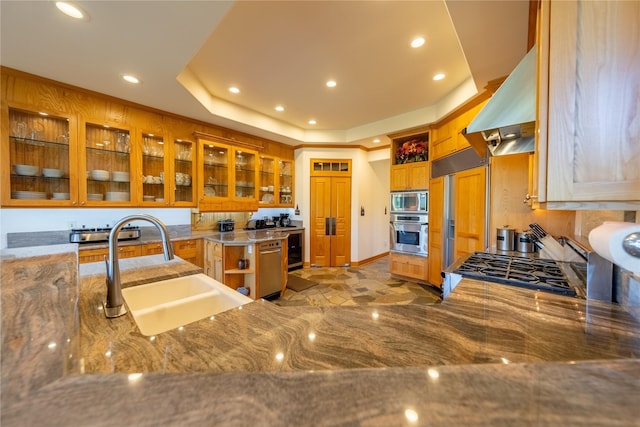 kitchen with open shelves, appliances with stainless steel finishes, a raised ceiling, and glass insert cabinets