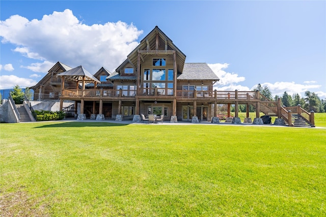 back of house featuring a patio area, a yard, stairway, and a wooden deck