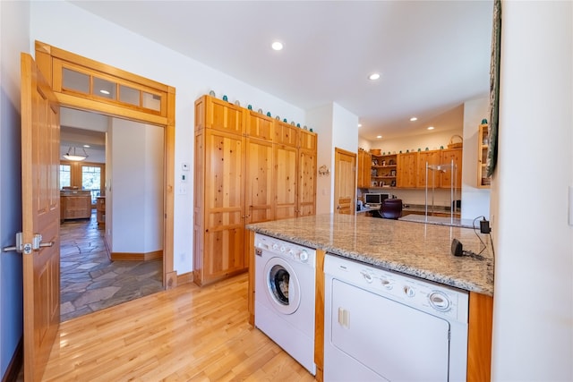 kitchen with light stone counters, light wood-style flooring, recessed lighting, brown cabinets, and open shelves