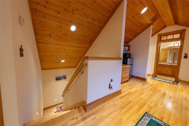 additional living space featuring visible vents, wood ceiling, vaulted ceiling, baseboards, and light wood-type flooring