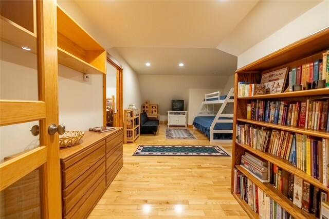 bedroom with light wood-type flooring, vaulted ceiling, and recessed lighting