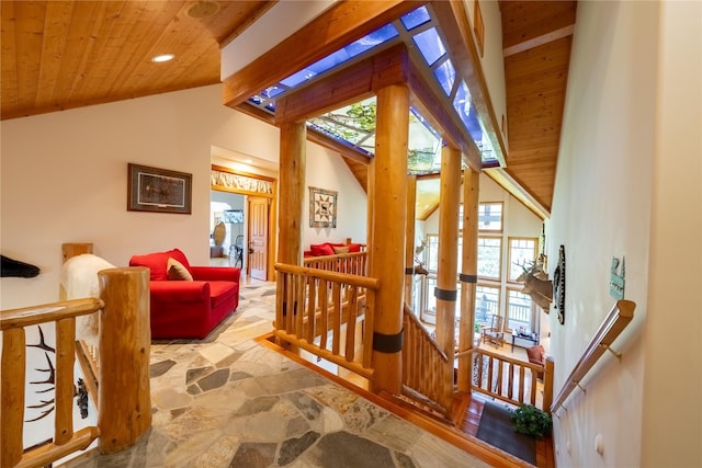 interior space featuring recessed lighting, stone flooring, an upstairs landing, high vaulted ceiling, and wooden ceiling