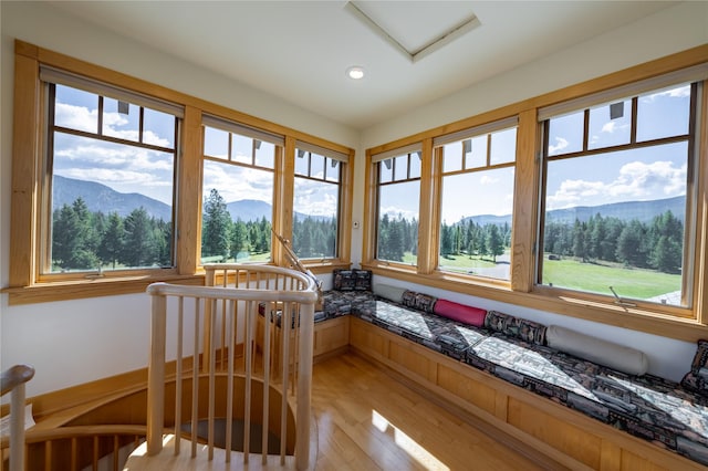 sunroom with plenty of natural light and a mountain view