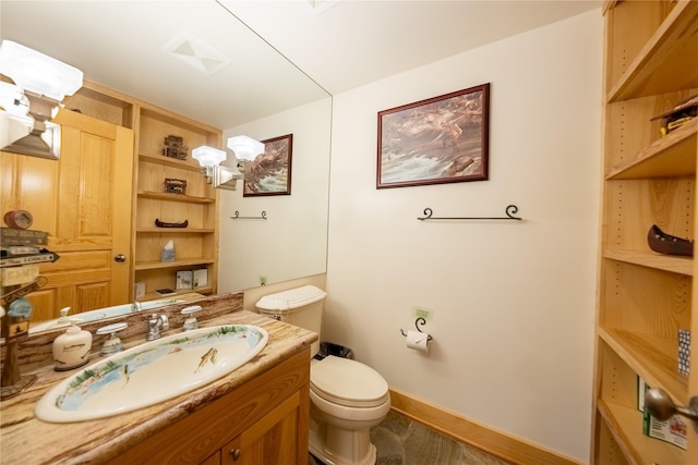 bathroom featuring toilet, baseboards, visible vents, and vanity