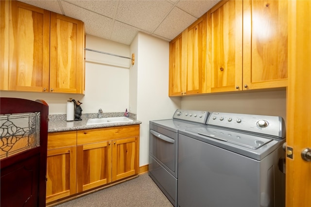 laundry room with a sink, cabinet space, and washer and dryer