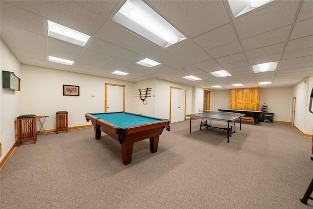 recreation room with carpet, a drop ceiling, and baseboards