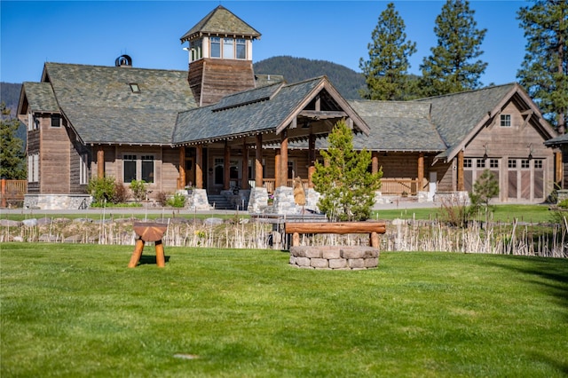 rear view of property with a lawn