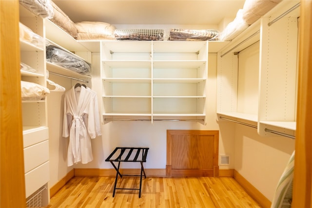 walk in closet featuring light wood-type flooring and visible vents