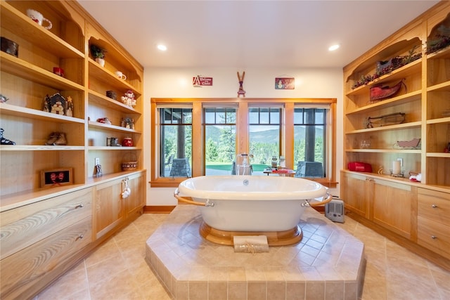 full bathroom with recessed lighting, a soaking tub, built in features, and tile patterned floors