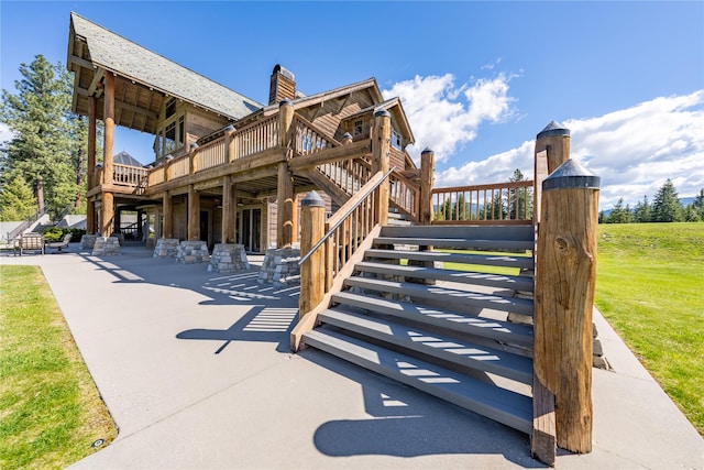 view of property's community featuring a patio area, stairway, and a wooden deck