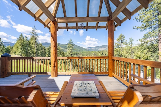 deck featuring a mountain view and outdoor dining space