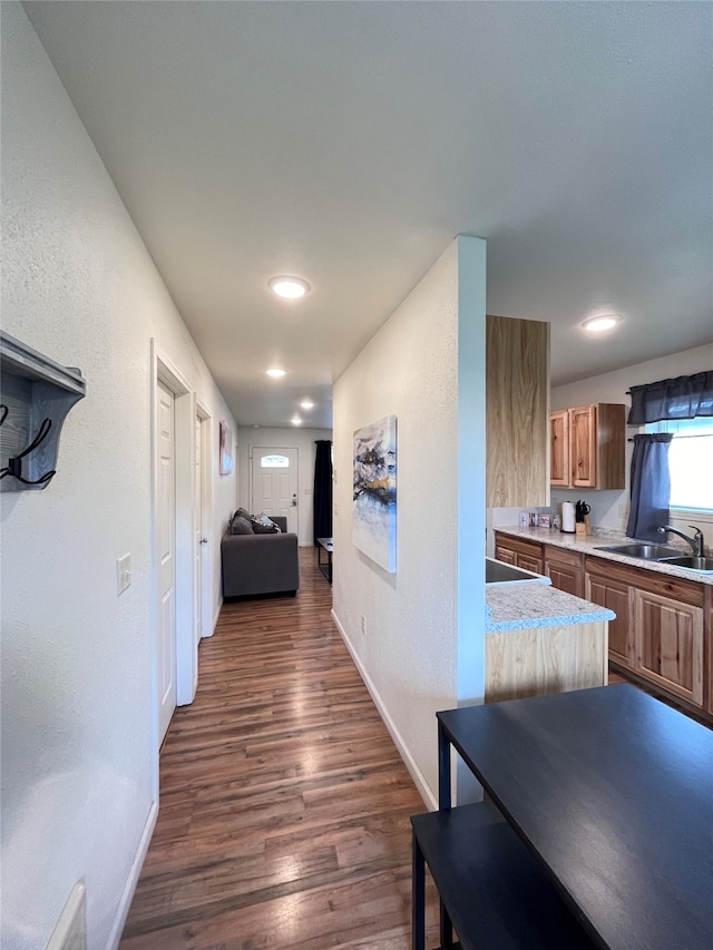 hallway with dark hardwood / wood-style flooring and sink