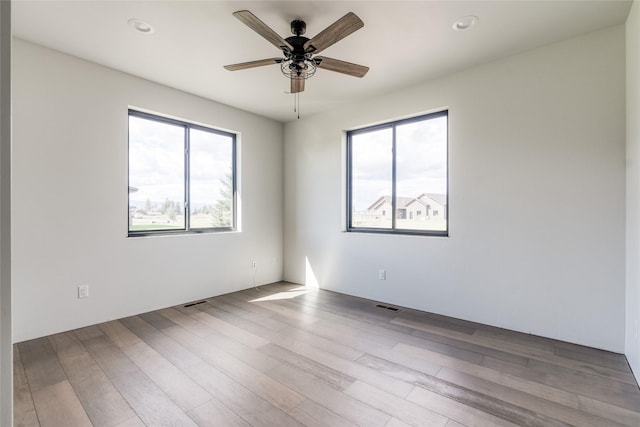 209 Mannington St, Kalispell, MT 59901 - unfurnished room featuring healthy amount of natural light, ceiling fan, wood finished floors, and recessed lighting