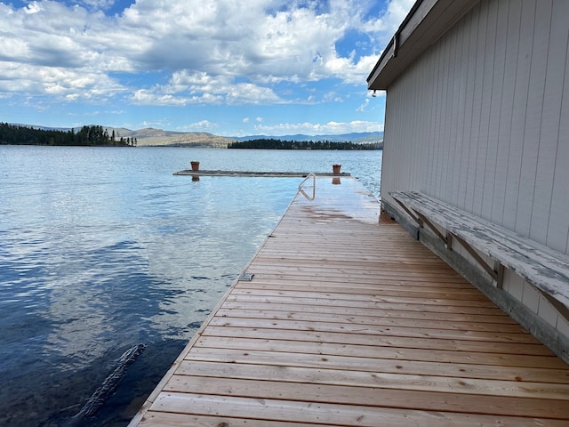 view of dock featuring a water and mountain view