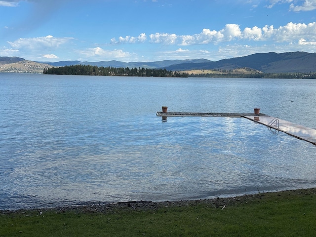 dock area featuring a water and mountain view