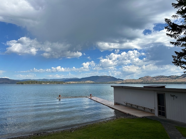 view of dock with a water and mountain view