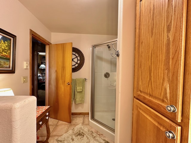 bathroom with tile patterned flooring and a shower with shower door