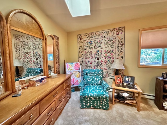 living area with lofted ceiling with skylight and light colored carpet