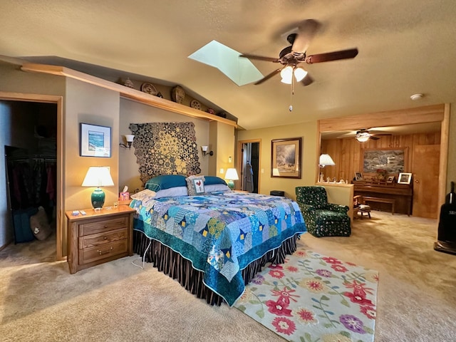 bedroom featuring light carpet, a closet, ceiling fan, and wooden walls