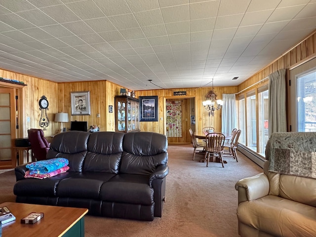 carpeted living room featuring a baseboard radiator and an inviting chandelier