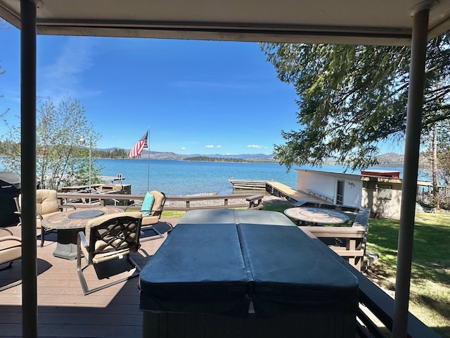 deck with a boat dock and a water and mountain view