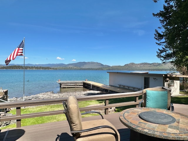 exterior space with a water and mountain view