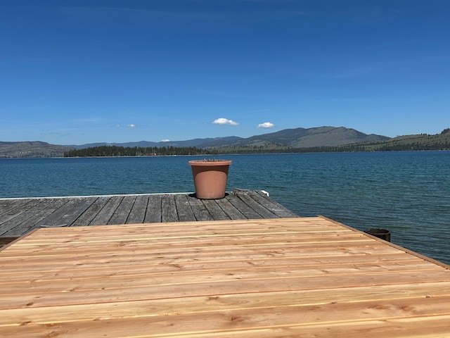 view of dock featuring a water and mountain view