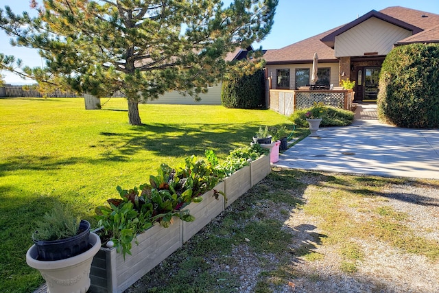 wooden terrace featuring a lawn