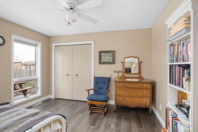 bedroom featuring a textured ceiling and dark wood-type flooring