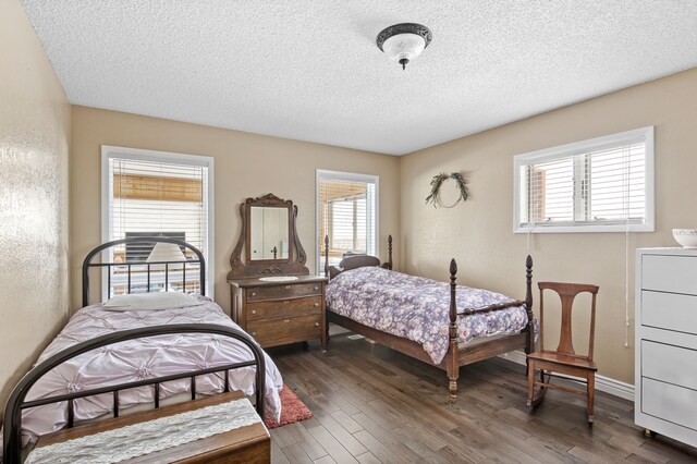 bedroom featuring a closet, a textured ceiling, and dark hardwood / wood-style floors