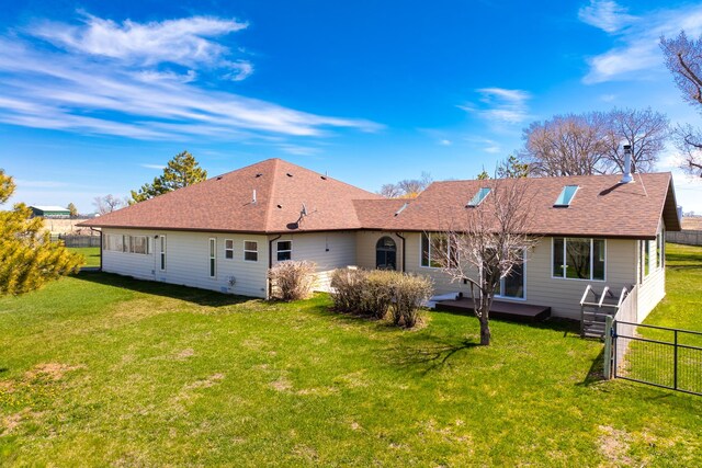 rear view of property featuring a deck