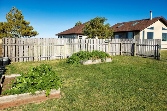 rear view of house featuring a yard