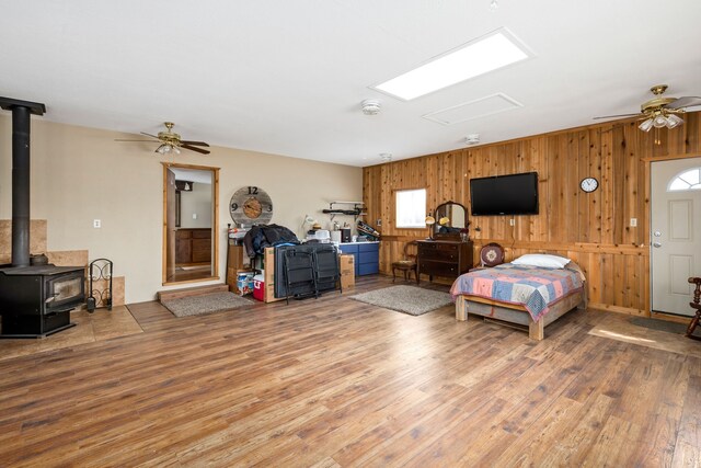 bedroom with wood walls and wood-type flooring