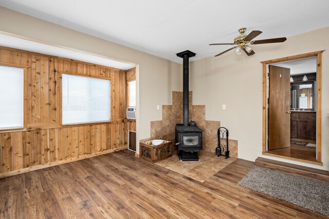 bathroom featuring toilet, hardwood / wood-style flooring, water heater, and vanity