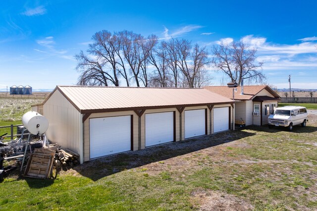 garage featuring a lawn