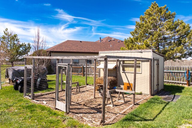 view of outdoor structure with a yard and a rural view