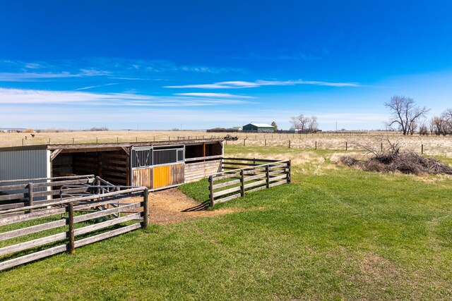 view of outdoor structure with a rural view and a lawn