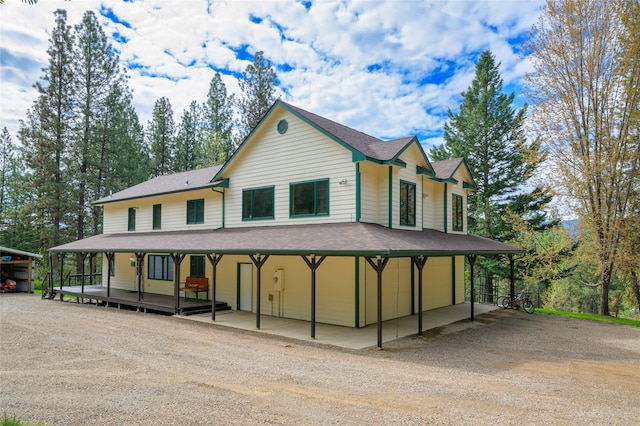 farmhouse inspired home featuring a carport